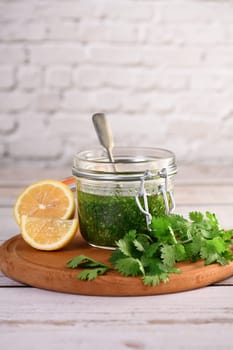 Green delicious herbal marinade of cilantro, basil, parsley, oil, traditional seasoning for salad dressing