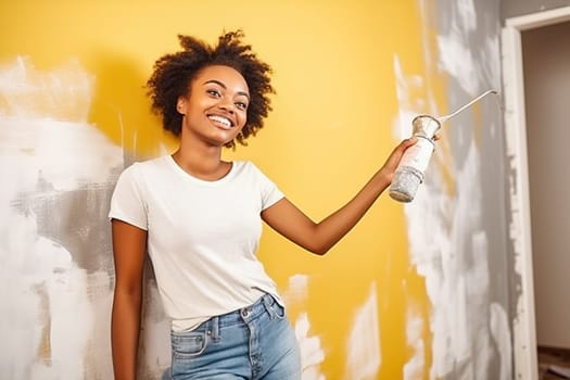 Happy African American woman painting a wall. Repair concept. High quality photo