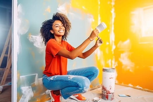 Happy African American woman painting a wall. Repair concept. High quality photo