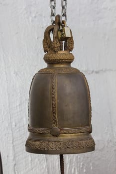 Big brass bells are commonly hung in Thai temples.