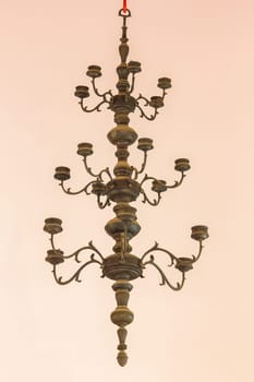 Candlestick, old brass, hanging on the ceiling