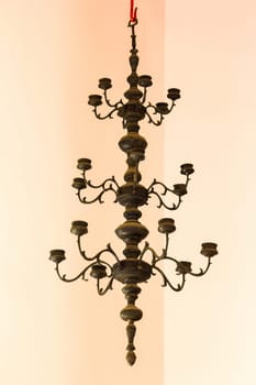 Candlestick, old brass, hanging on the ceiling