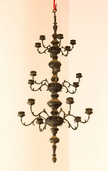 Candlestick, old brass, hanging on the ceiling