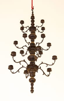 Candlestick, old brass, hanging on the ceiling