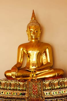 Beautiful golden Buddha On the pedestal, some white walls