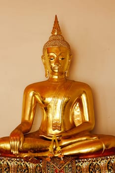 Beautiful golden Buddha On the pedestal, some white walls