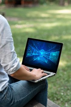 Woman Typing On Laptop Sitting Outside Side View Working From Home.