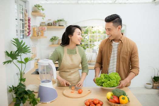 Attractive couple is cooking on kitchen.