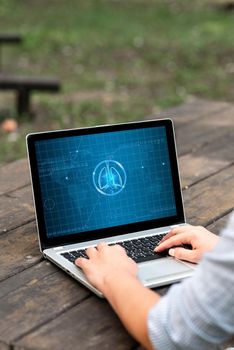 Laptop Placed Resting On Table Working In The Park Doing Remote Jobs.