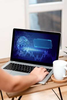 Hand Resting On Laptop Top Of Table Beside Cup Working From Home.