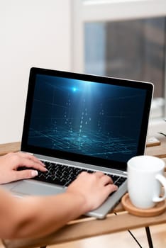 Both Hands Typing On Laptop Next To Cup And Plant Working From Home.