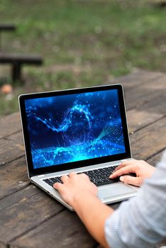 Laptop Placed Resting On Table Working In The Park Doing Remote Jobs.