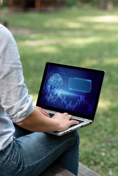 Woman Typing On Laptop Sitting Outside Side View Working From Home.