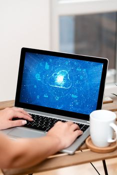 Both Hands Typing On Laptop Next To Cup And Plant Working From Home.