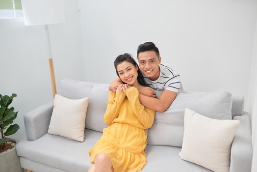 Couple at home relaxing in sofa