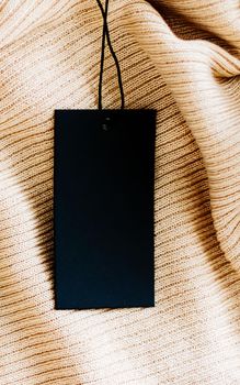 Luxury soft fabric and black vertical tag, sustainable fashion and brand label concept.