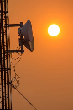 Antenna on a high rise building with sunset time