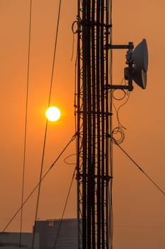 Antenna on a high rise building with sunset time