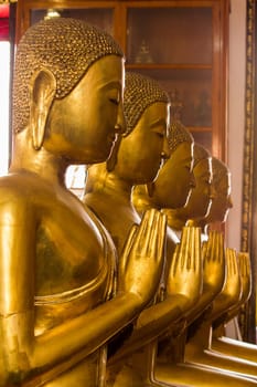 Beautiful golden Buddha On the pedestal, some white walls