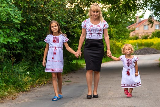Family Ukrainians in vyshyvanka mother and children. Selective focus. victory,