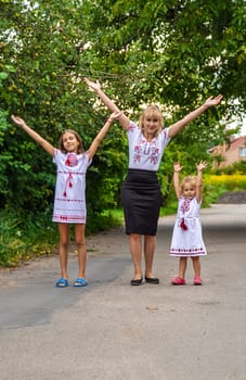 Family Ukrainians in vyshyvanka mother and children. Selective focus. victory,