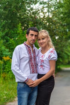 Ukrainian man and woman in vyshyvanka. Selective focus. victory,
