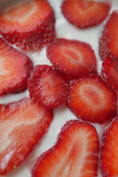 Yogurt and strawberry in a bowl on white .