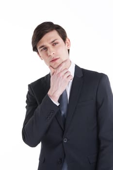 Portrait young business man holding hand in his chin while looking pensively at the camera isolated on white background