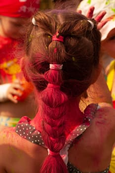 Photography girl back view hairstyle braid holiday holly. Bright colors.