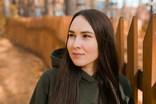 Beautiful smiling woman walking outdoors in autumn