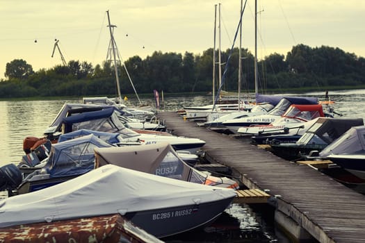 Photo of mooring motor boats and boats near shore. Navigation.