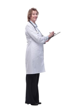 Side view of female doctor holding a clipboard and writing in it- isolated over a white background