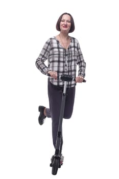 in full growth. attractive mature woman with electric scooter. isolated on a white background.