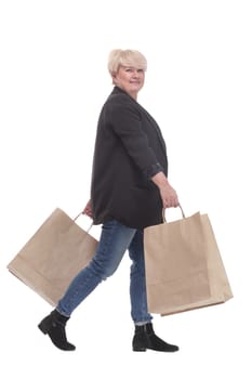 full-length. casual mature woman with shopping bags . isolated on a white background.