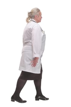 Profile of serious doctor woman walking and ready to help isolated over white background with copy space.