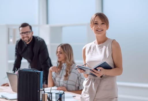 young businesswoman making notes in a notebook. business concept