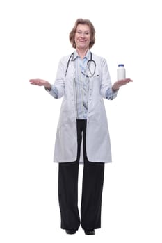A woman doctor with a phonendoscope holds white jars of medicine in her hands and smiling at camera