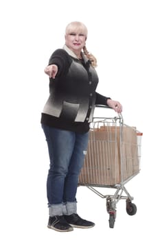 full-length. casual woman in jeans with shopping cart. isolated on a white background.