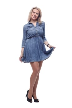 in full growth. thoughtful young woman in a denim dress looking at a white screen. isolated on a white background.