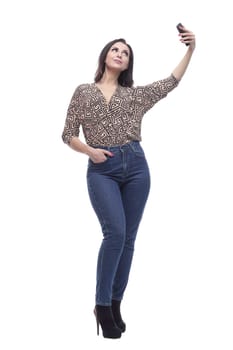 in full growth. attractive young woman with a smartphone. isolated on a white background.