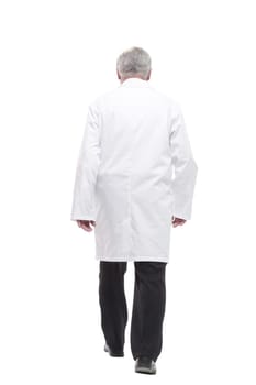 qualified mature doctor with stethoscope stepping forward. isolated on a white background.