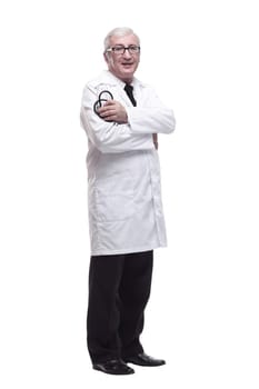 in full growth.friendly mature doctor with a stethoscope in hand. isolated on a white background.