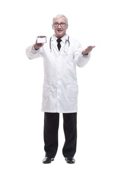 in full growth.qualified mature doctor showing his visiting card . isolated on a white background.