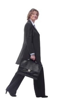 Smiling mature businesswoman walking to side with briefcase isolated on white background