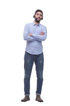in full growth. friendly young man in a headset looking at you. isolated on a white background.