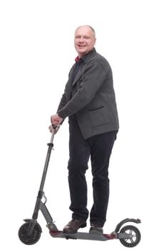 in full growth. happy casual man with electric scooter .isolated on a white background.