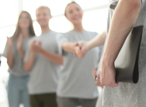 blurred image of a group of young people sitting in a circle. photo with copy space