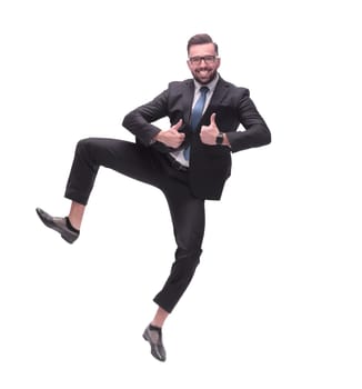 in full growth. happy dancing young businessman. isolated on white background
