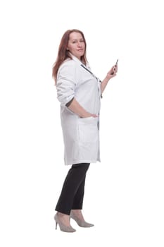 in full growth. qualified female doctor with a smartphone. isolated on a white background.