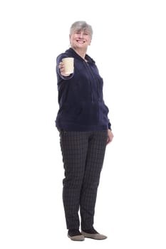 in full growth. contented old woman with a takeaway coffee . isolated on a white background.